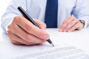 Businessman signing a document.